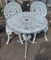 A white metal garden table and two chairs