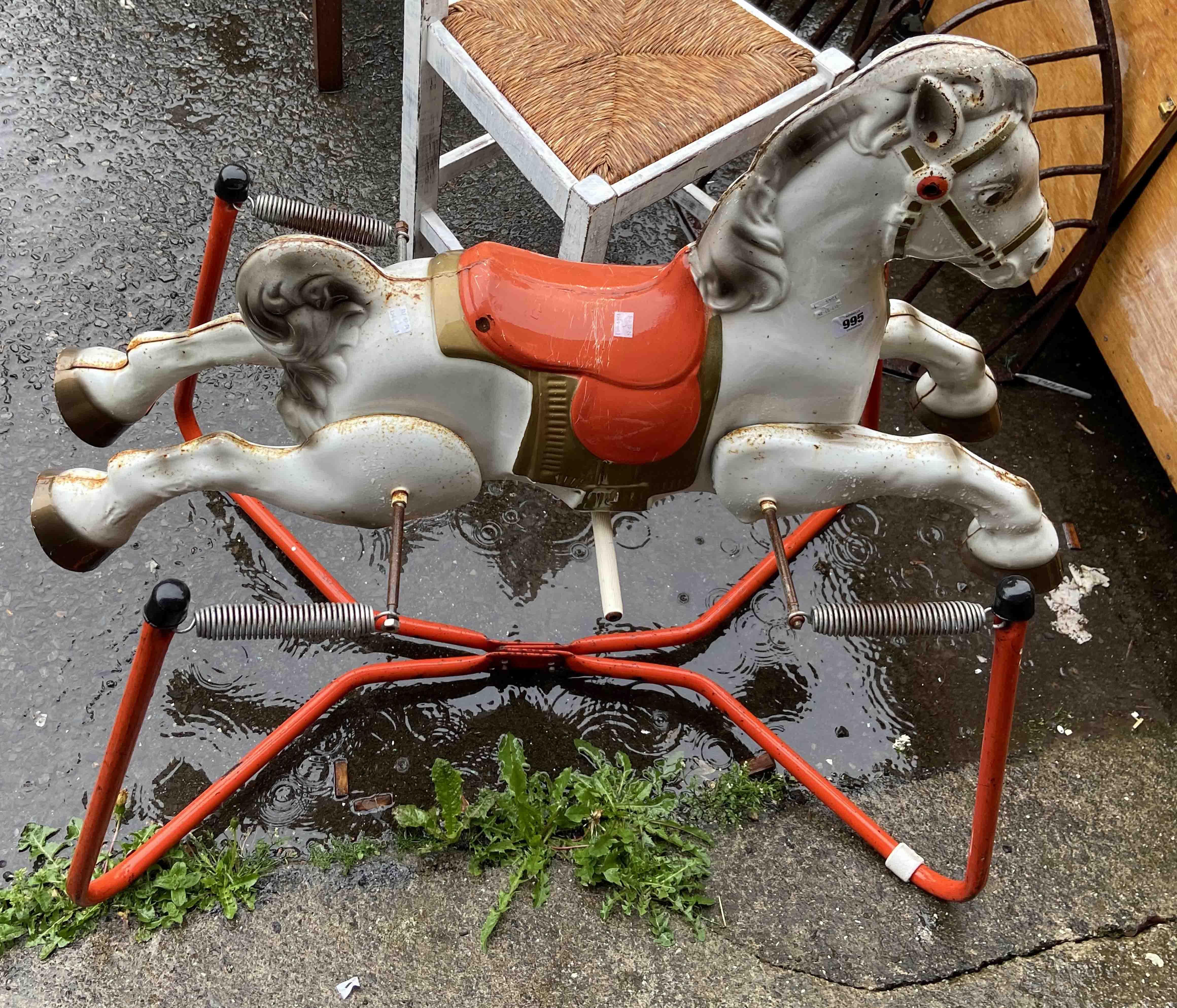 A late 1950's Mobo 'Prairie King' painted pressed metal rocking horse, set on a sprung base