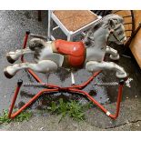 A late 1950's Mobo 'Prairie King' painted pressed metal rocking horse, set on a sprung base