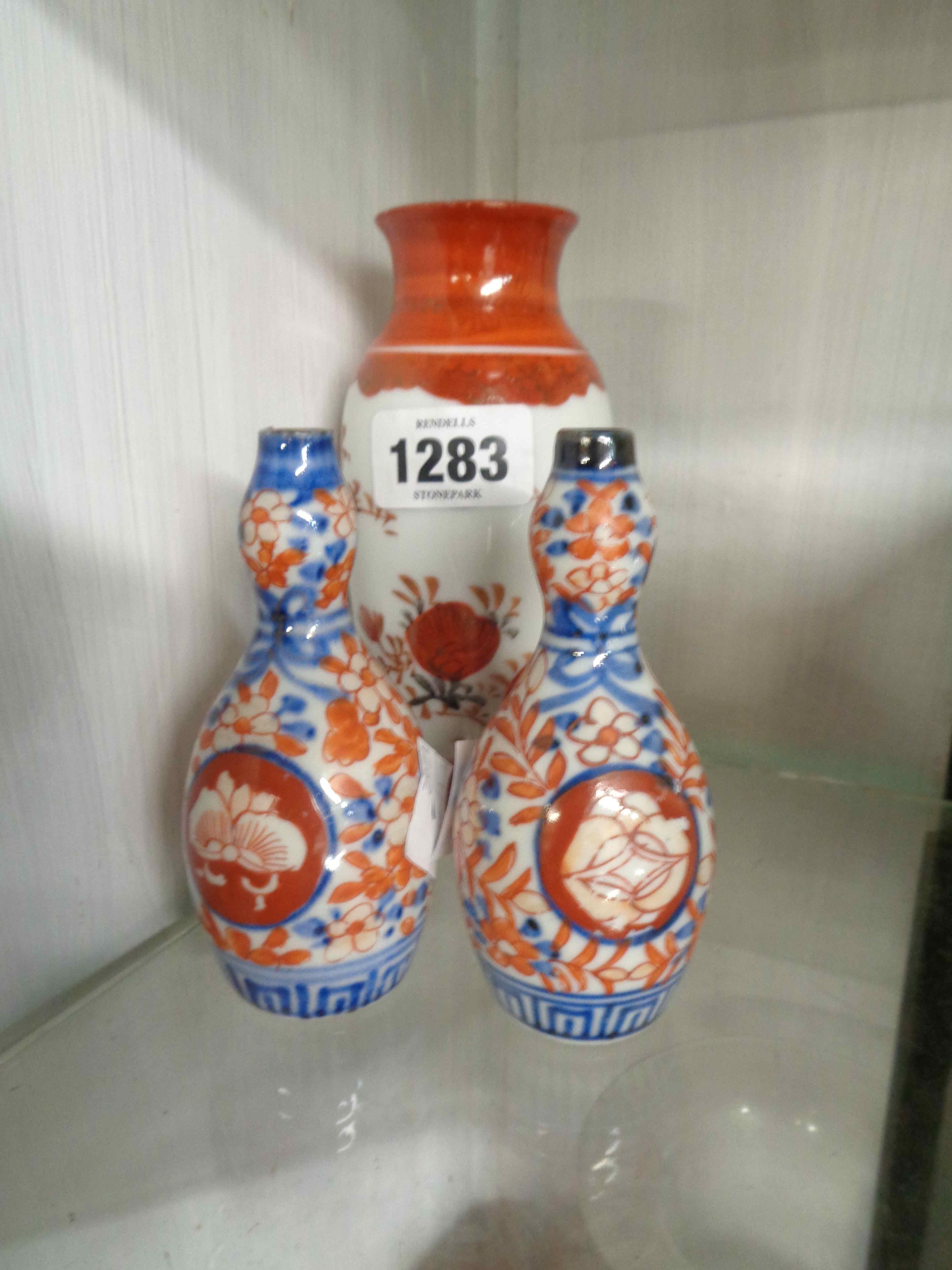 A pair of small old Japanese Imari vases of globe bottle form with painted decoration - sold with