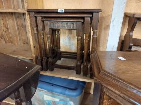 A vintage oak nest of three tea tables, set on turned supports