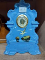 A Torquay pottery cased mantel timepiece with seagulls and rocks on blue glazed ground and later