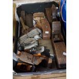 A box containing vintage woodworking planes, etc.