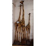 Three carved wood giraffe figures