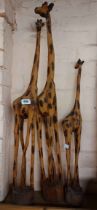 Three carved wood giraffe figures