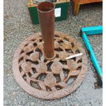 A heavy cast iron parasol base with pierced rose decoration