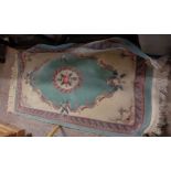 A modern machine made Chinese washed wool rug with floral decoration on pale ground