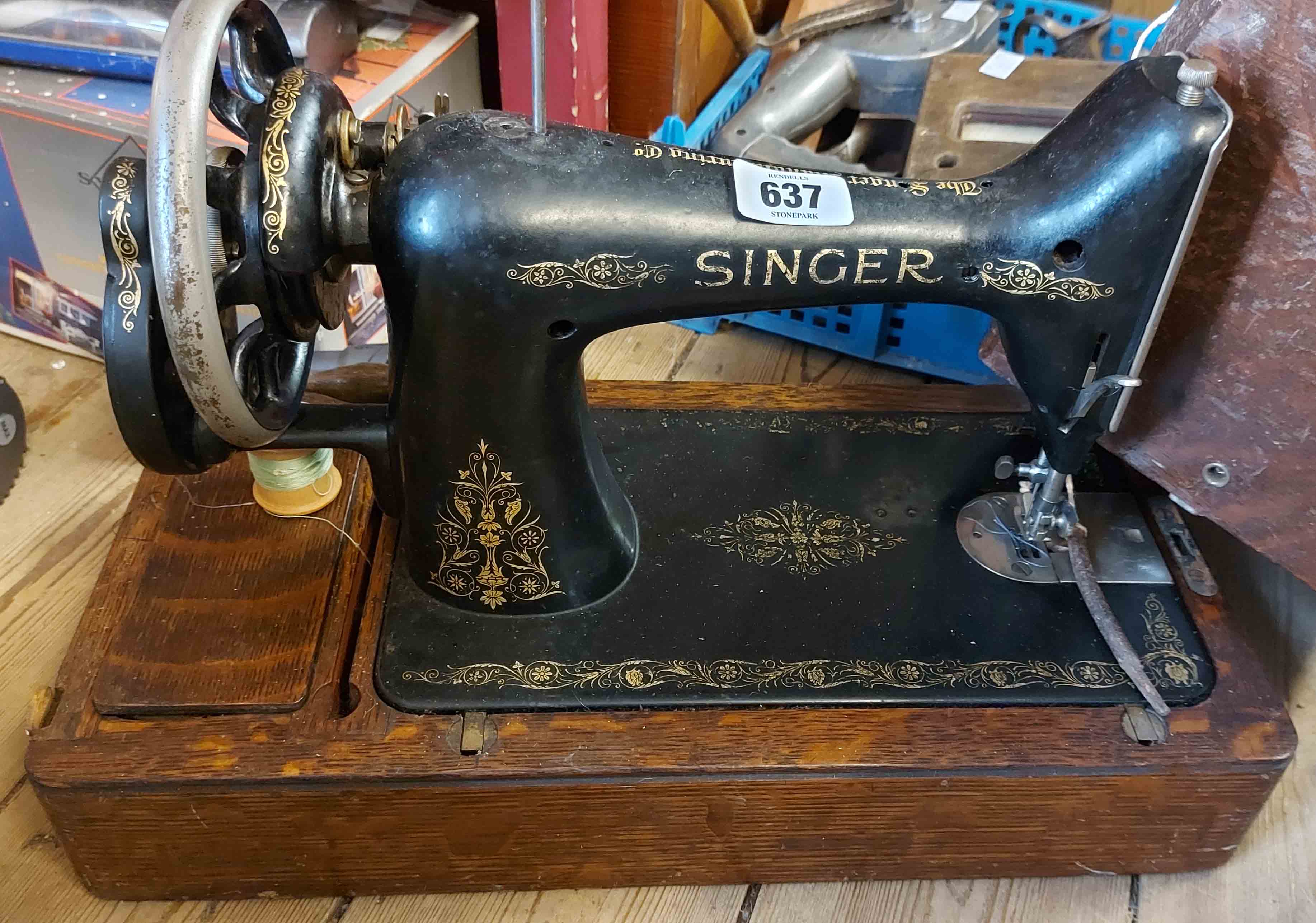 A vintage Singer sewing machine set within dome case