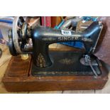 A vintage Singer sewing machine set within dome case