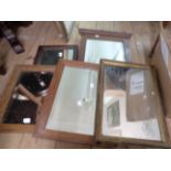 Four assorted small oak framed oblong wall mirrors - sold with a gilt framed similar