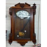 An early 20th Century stained walnut cased Vienna style regulator wall clock with visible pendulum