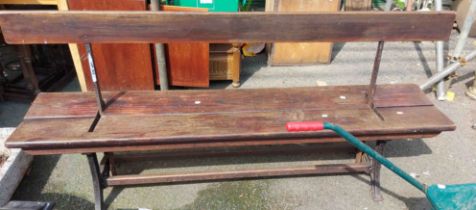 An early 20th Century Unity cast iron 'tram stop' style bench with slide action and wooden bench