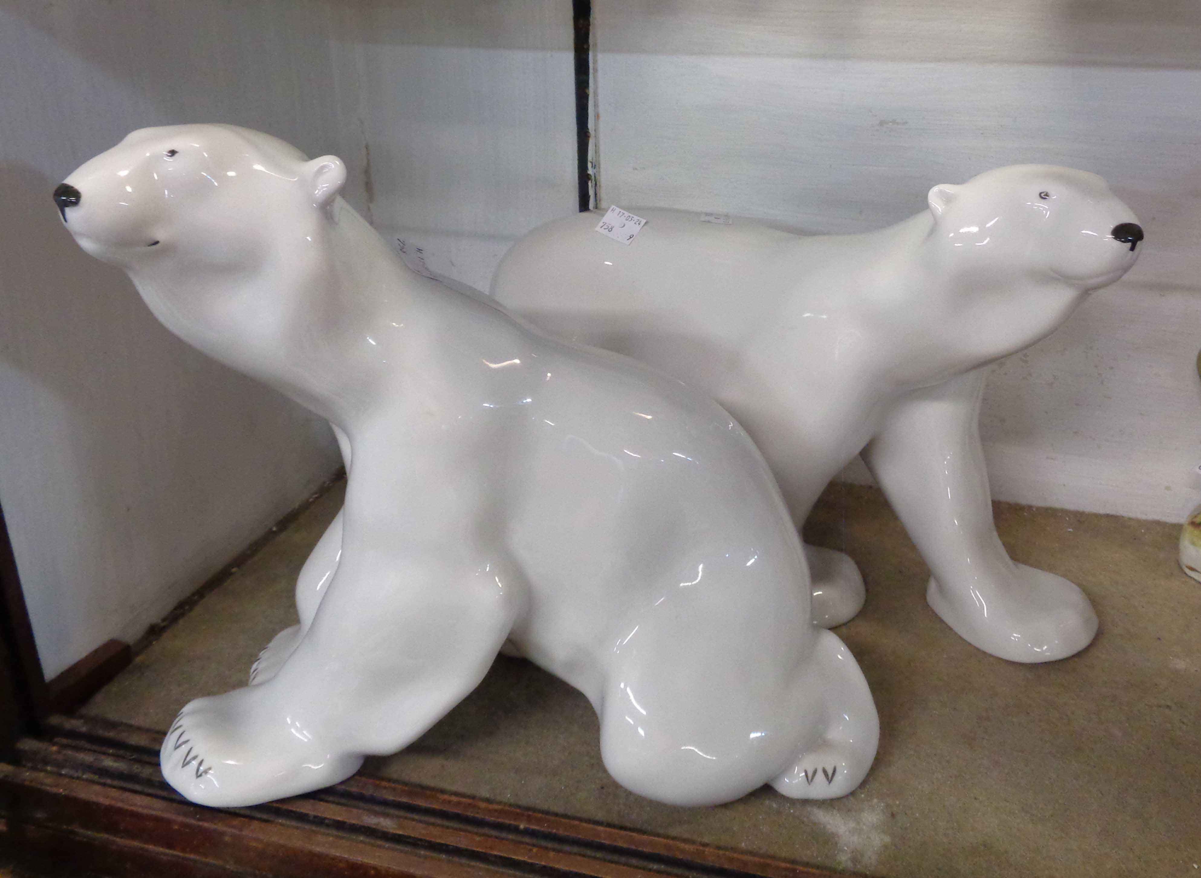 Two large Lomonosov Russian pottery Polar Bear figurines, with painted detailing and a white glaze