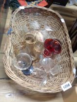 A basket containing a quantity of glassware