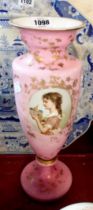 A 19th Century opaque glass vase, cased pink over white with a decorative panel, depicting a girl