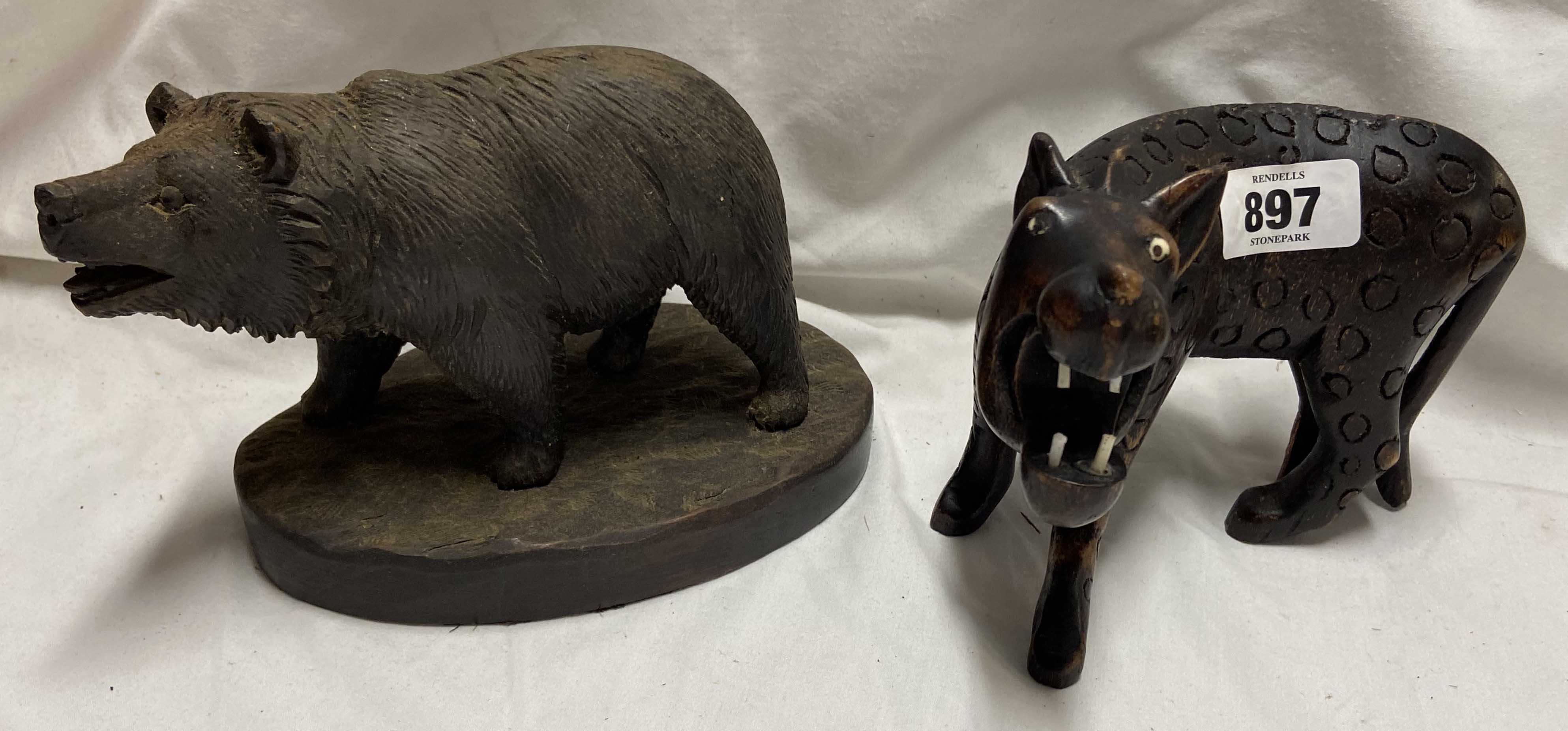 A Black Forrest carved wood bear - sold with a carved hardwood figure, depicting a primitive