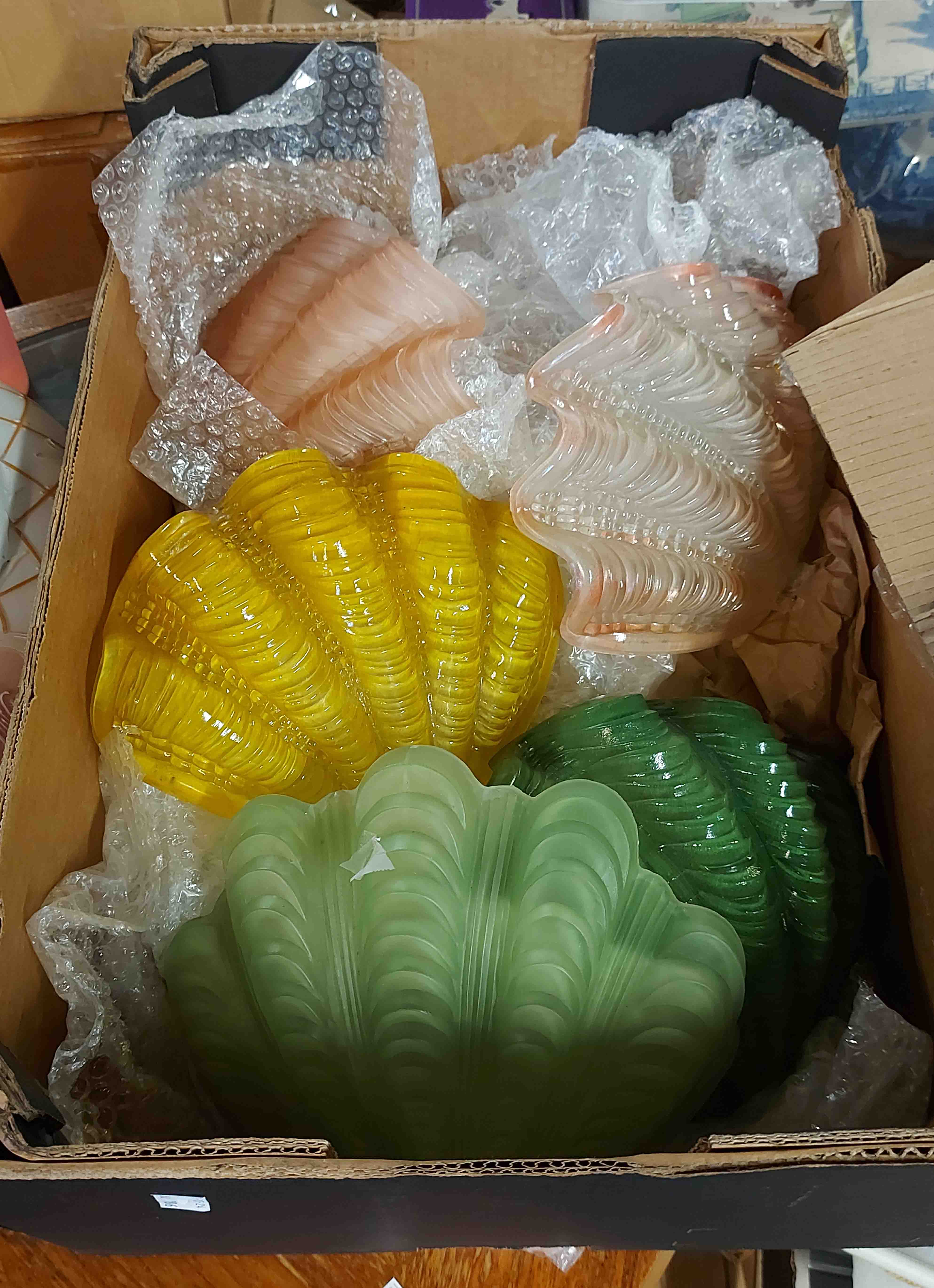Eight Art Deco glass clam shell wall light shades in various colours