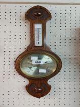 A small polished oak banjo barometer/thermometer by Comitti of London with gilt dial and aneroid