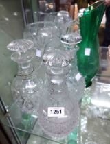 A quantity of glassware comprising three decanters, vase and green jug