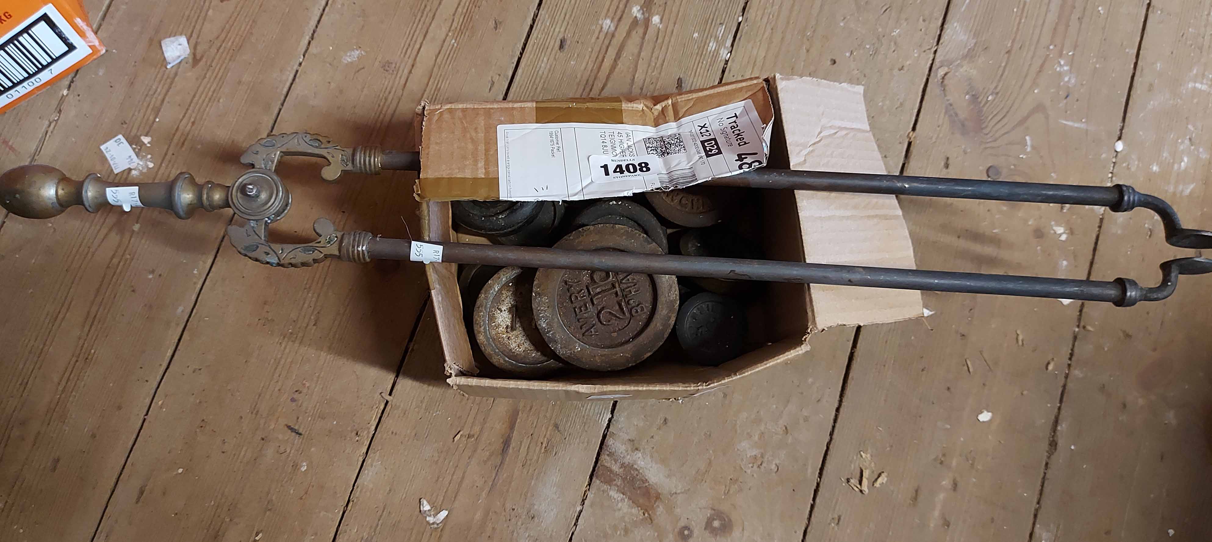 A box containing a quantity of weights and fire tongs