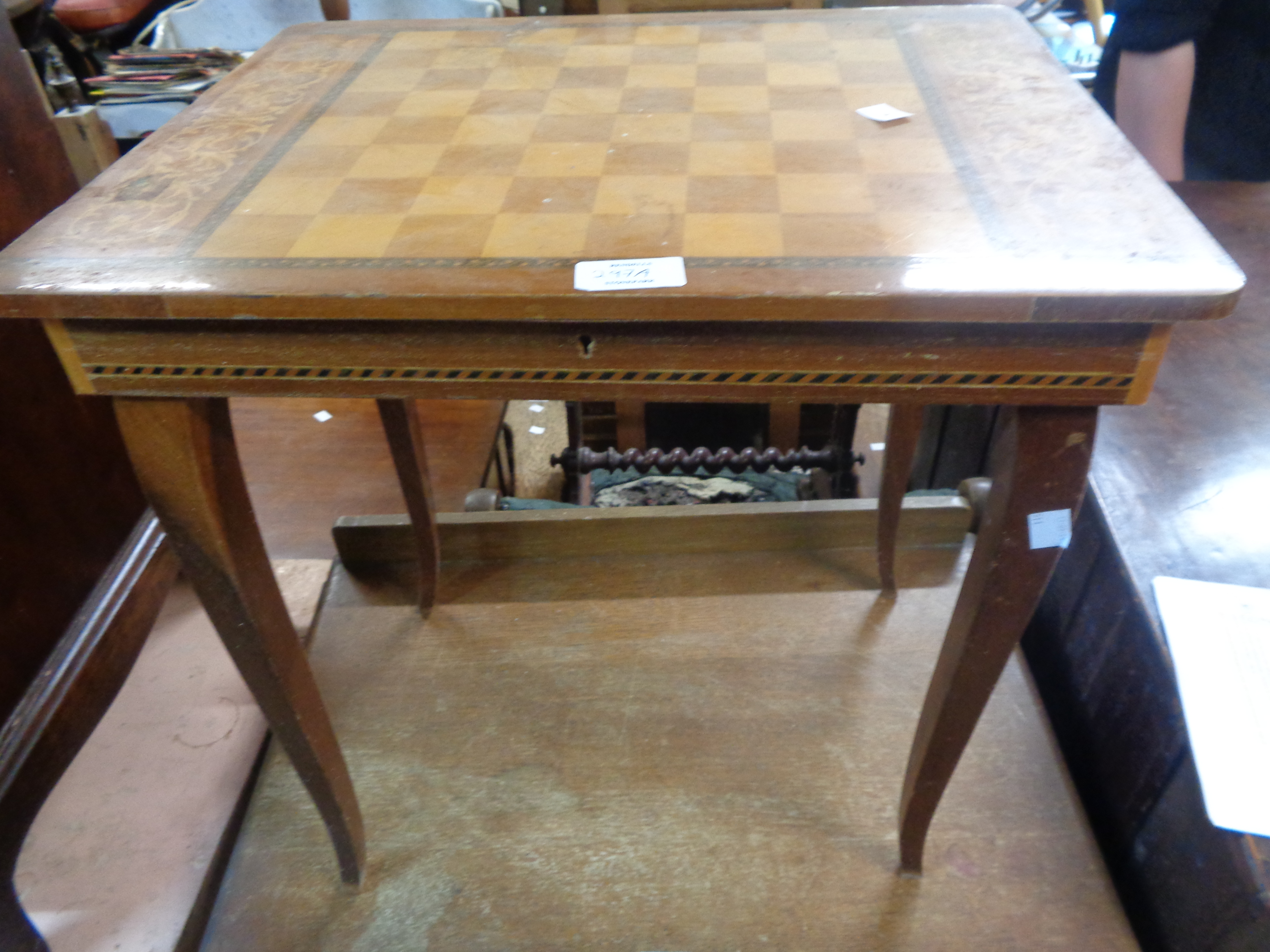 A Sorrento ware lift-top games table with musical movement