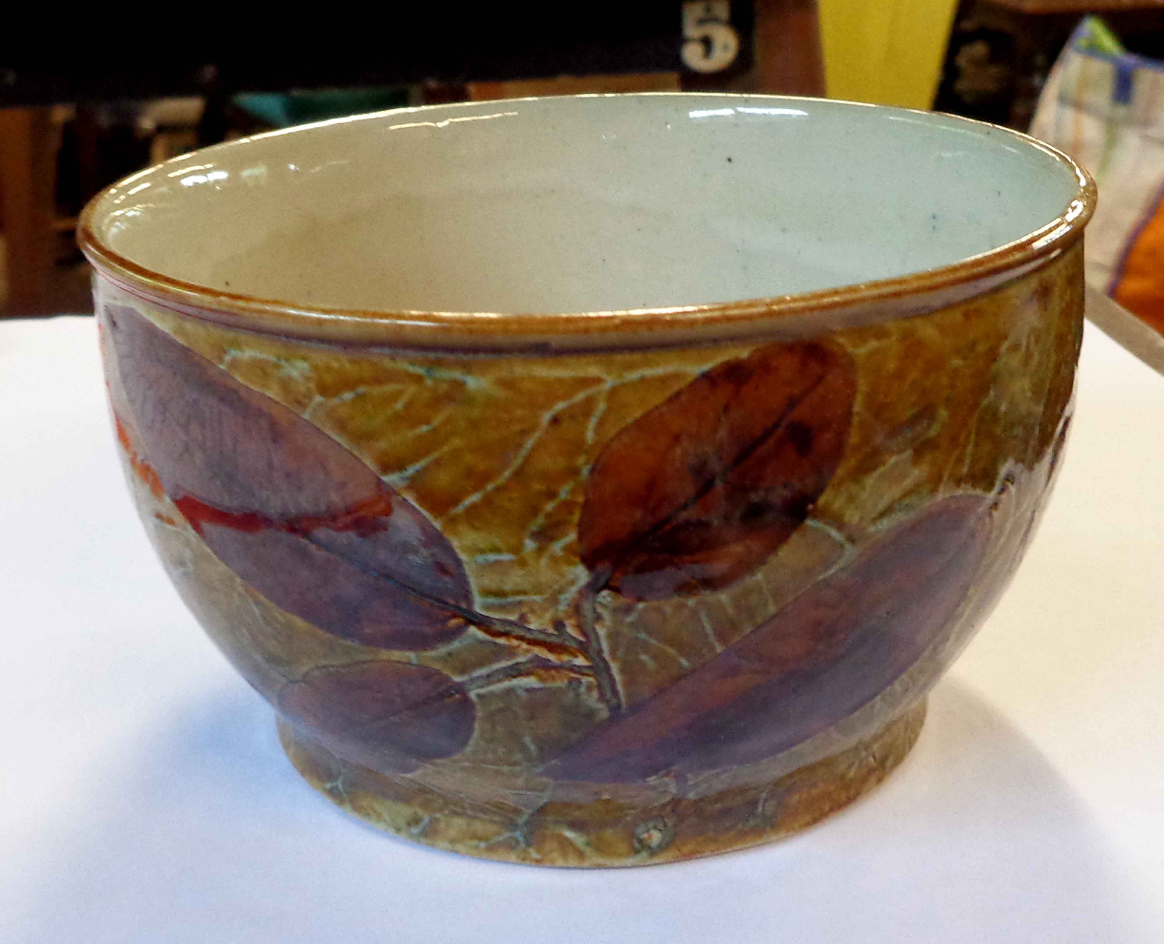 A small Doulton Lambeth stoneware bowl with impressed leaf decoration