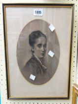 A Hogarth framed and oval slipped monochrome pencil drawing head and shoulders portrait of a lady