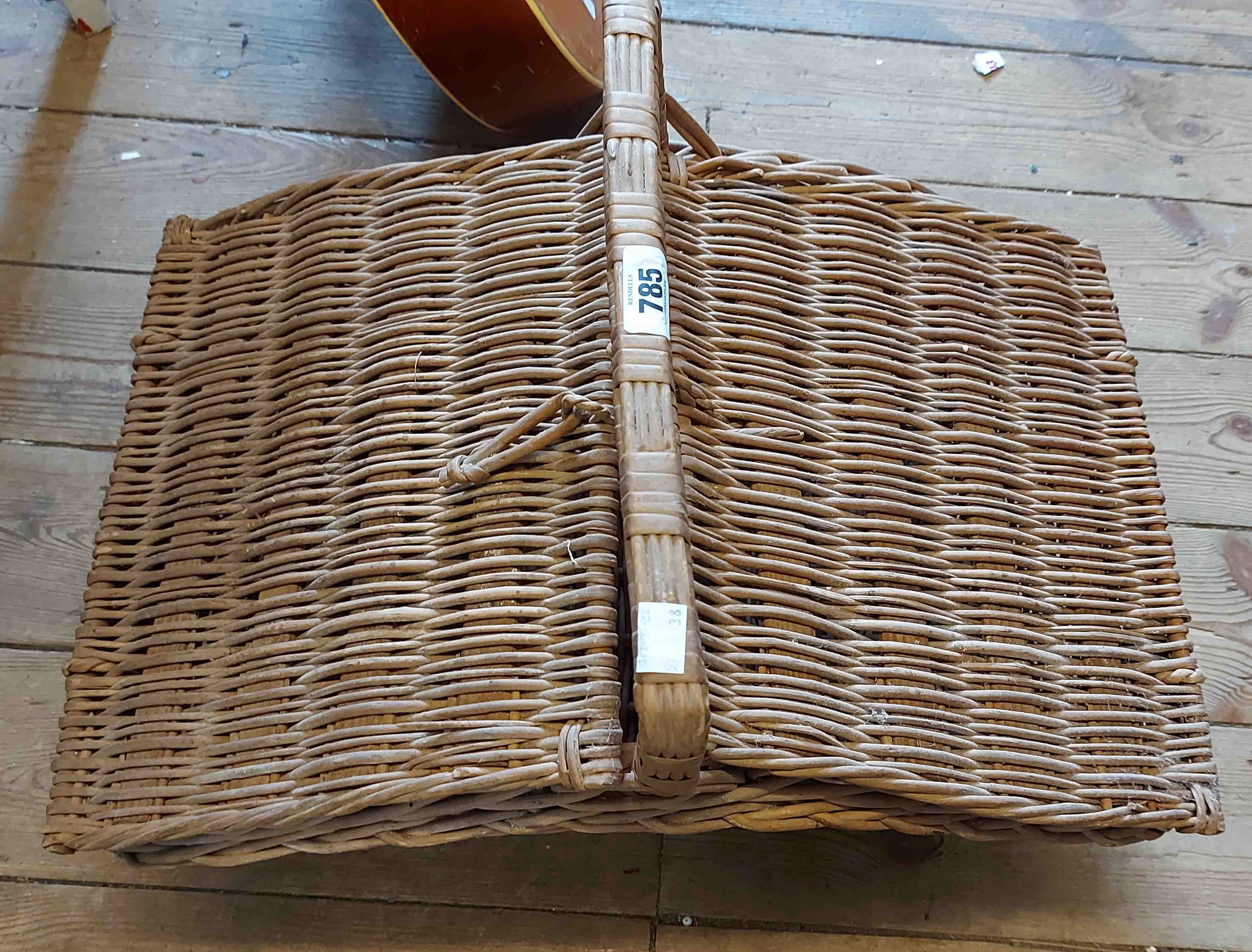 An old lift-top wicker picnic basket