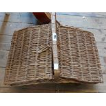 An old lift-top wicker picnic basket