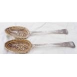 A pair of antique silver berry spoons with ornate embossed and engraved decoration - original spoons