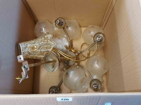 A brass five branch electrolier with opaque globe glass shades - sold with a tealight stand