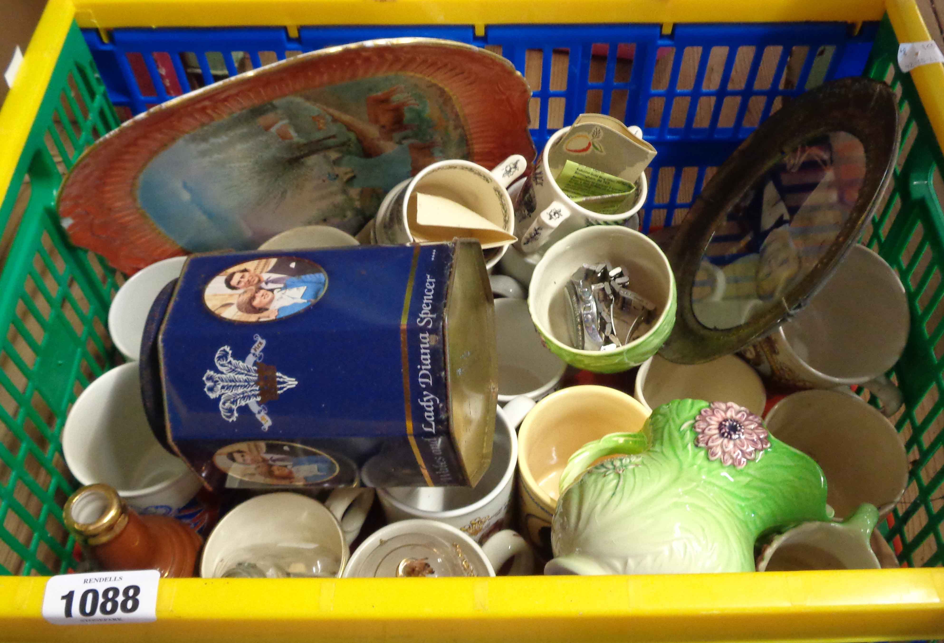 A crate containing a quantity of ceramics including commemorative mugs, Taunton Cider loving cups,