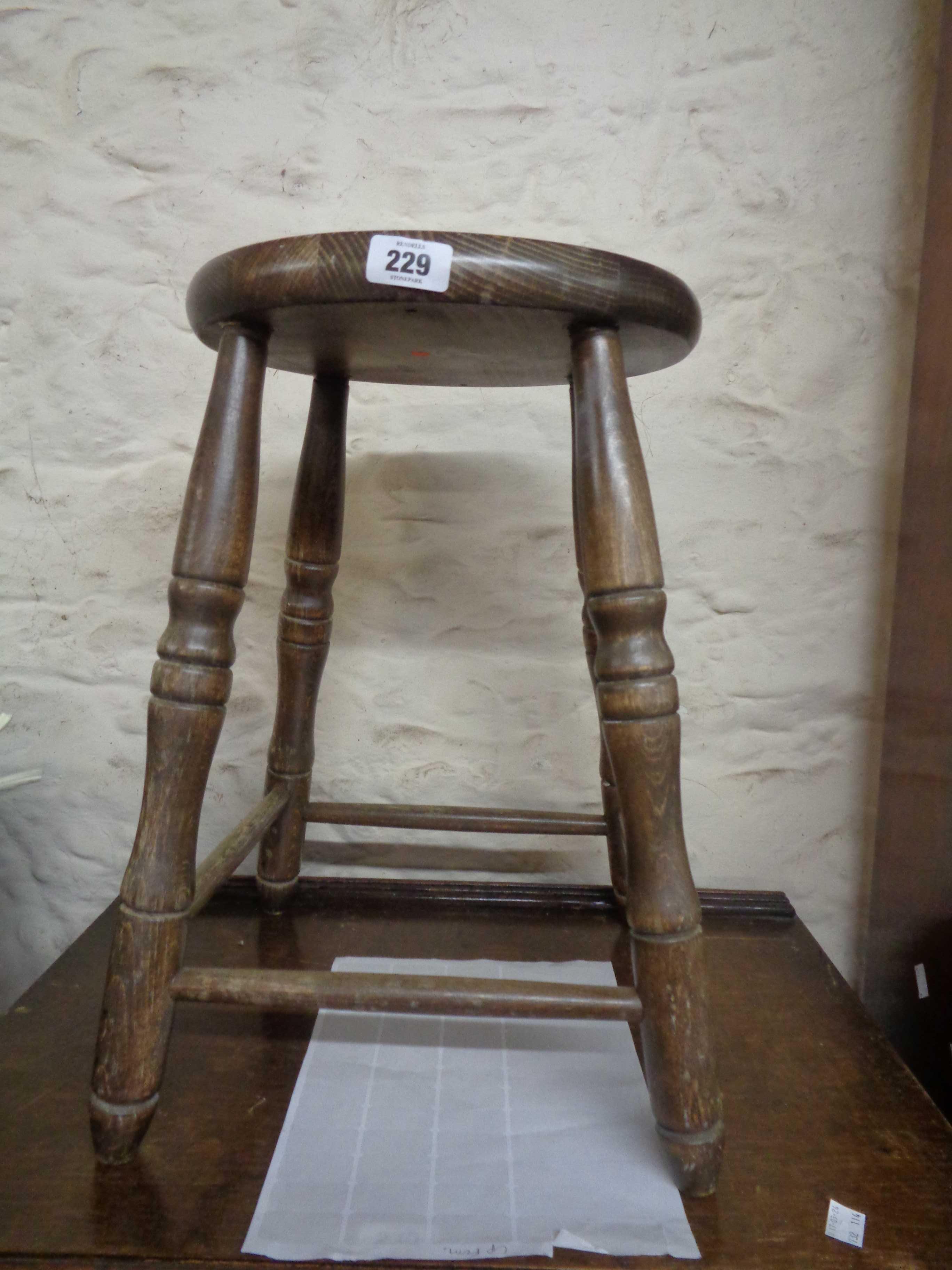 A vintage stained mixed wood kitchen stool