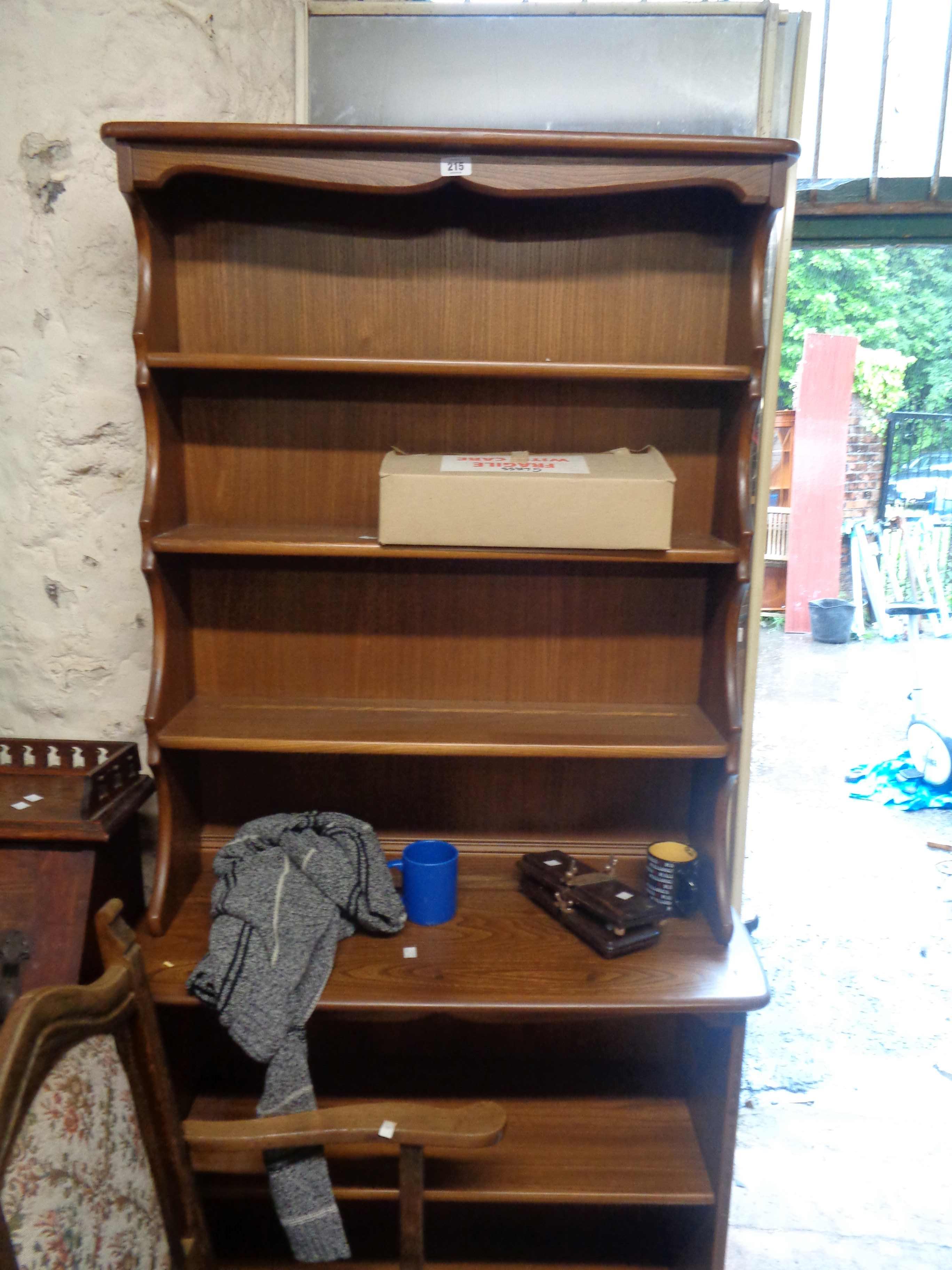 A 92cm Ercol dark elm two part dresser with three shelf open plate rack and adjustable shelf