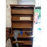 A 92cm Ercol dark elm two part dresser with three shelf open plate rack and adjustable shelf