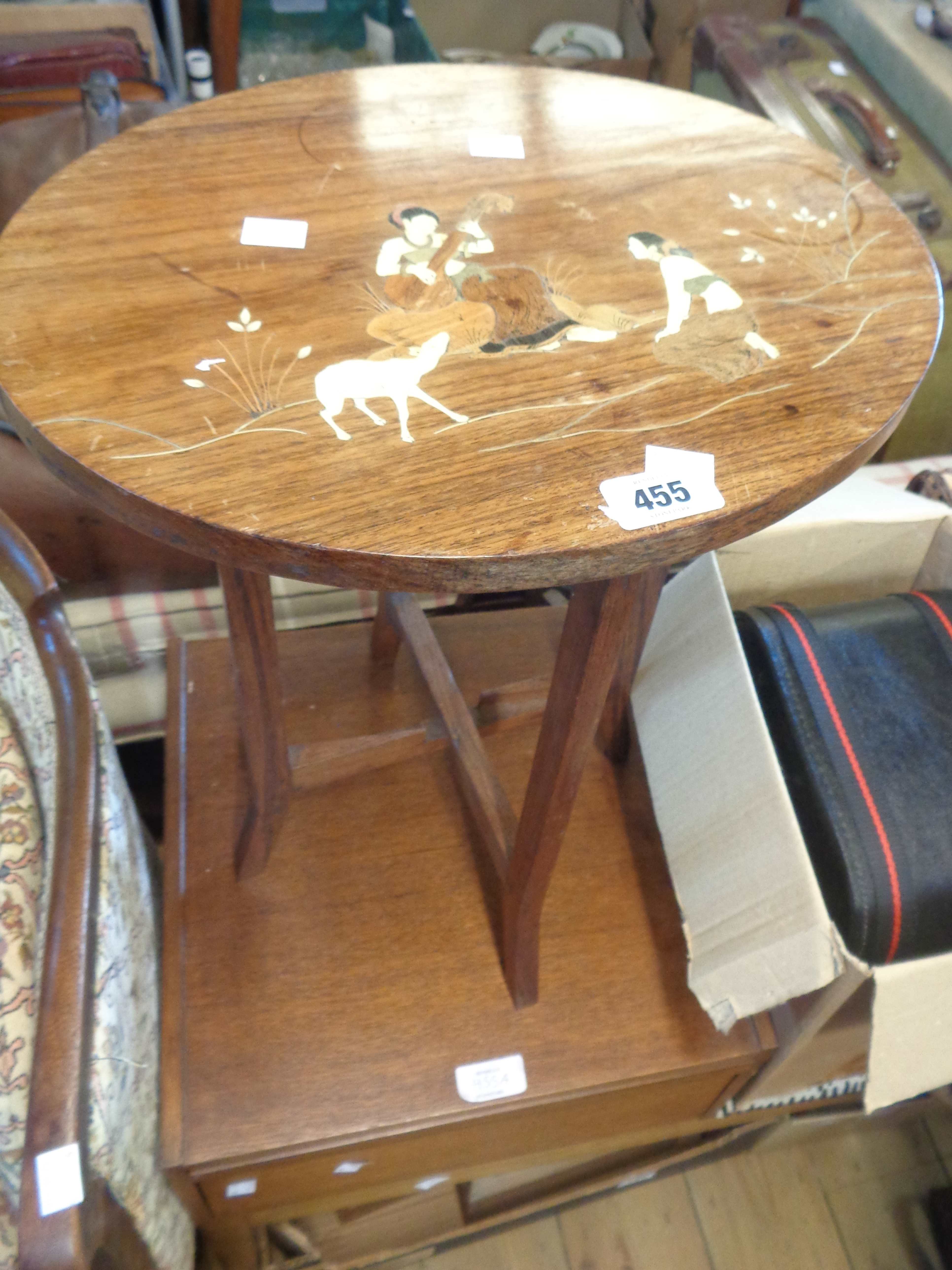 A 38cm old Indian hardwood tea table with inlaid ivory decoration depicting musicians and goat,