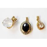 Three 375 (9ct.) gold gem set pendant comprising black onyx, milky quartz and a clear quartz