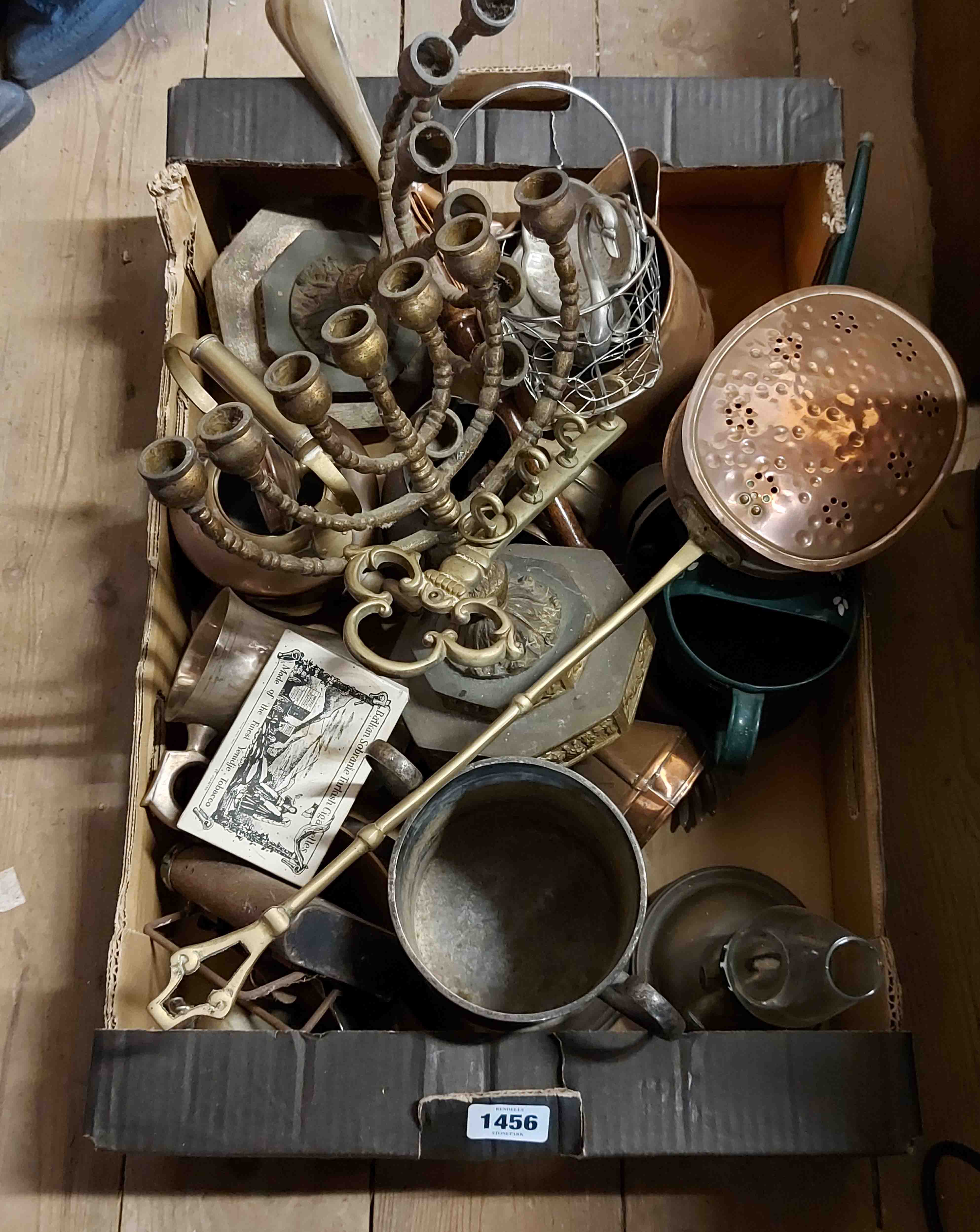 A box containing a quantity of metalware including two vintage brass Menorahs, chestnut roaster,