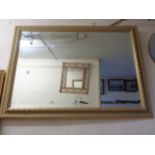 A modern gilt framed bevelled oblong wall mirror with fluted border