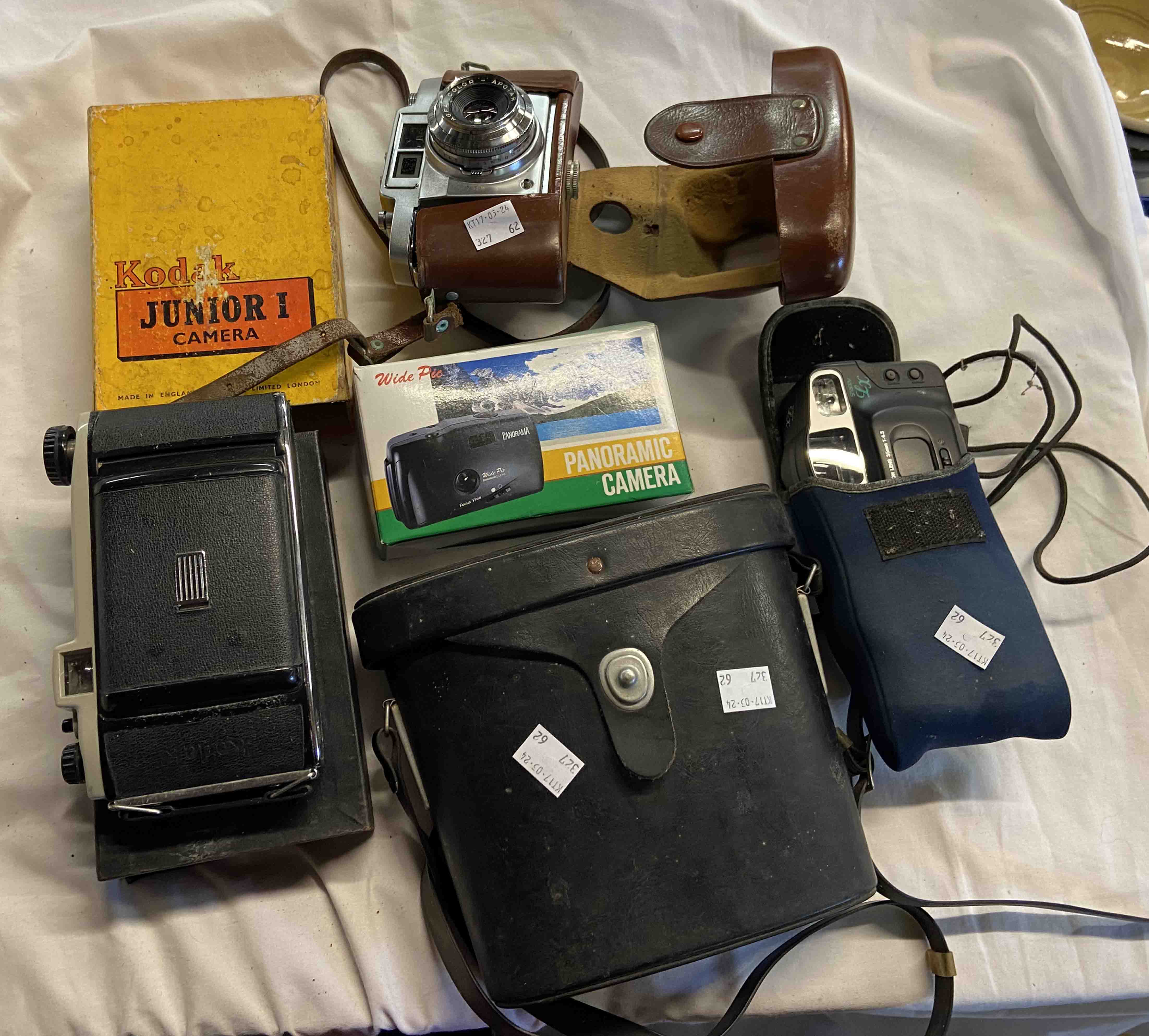 A quantity old cameras and cased binoculars including Swiss Grand Prix binoculars, a Kodak Junior