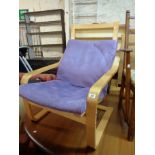 An Ikea blonde bentwood framed rocking elbow chair with cushion