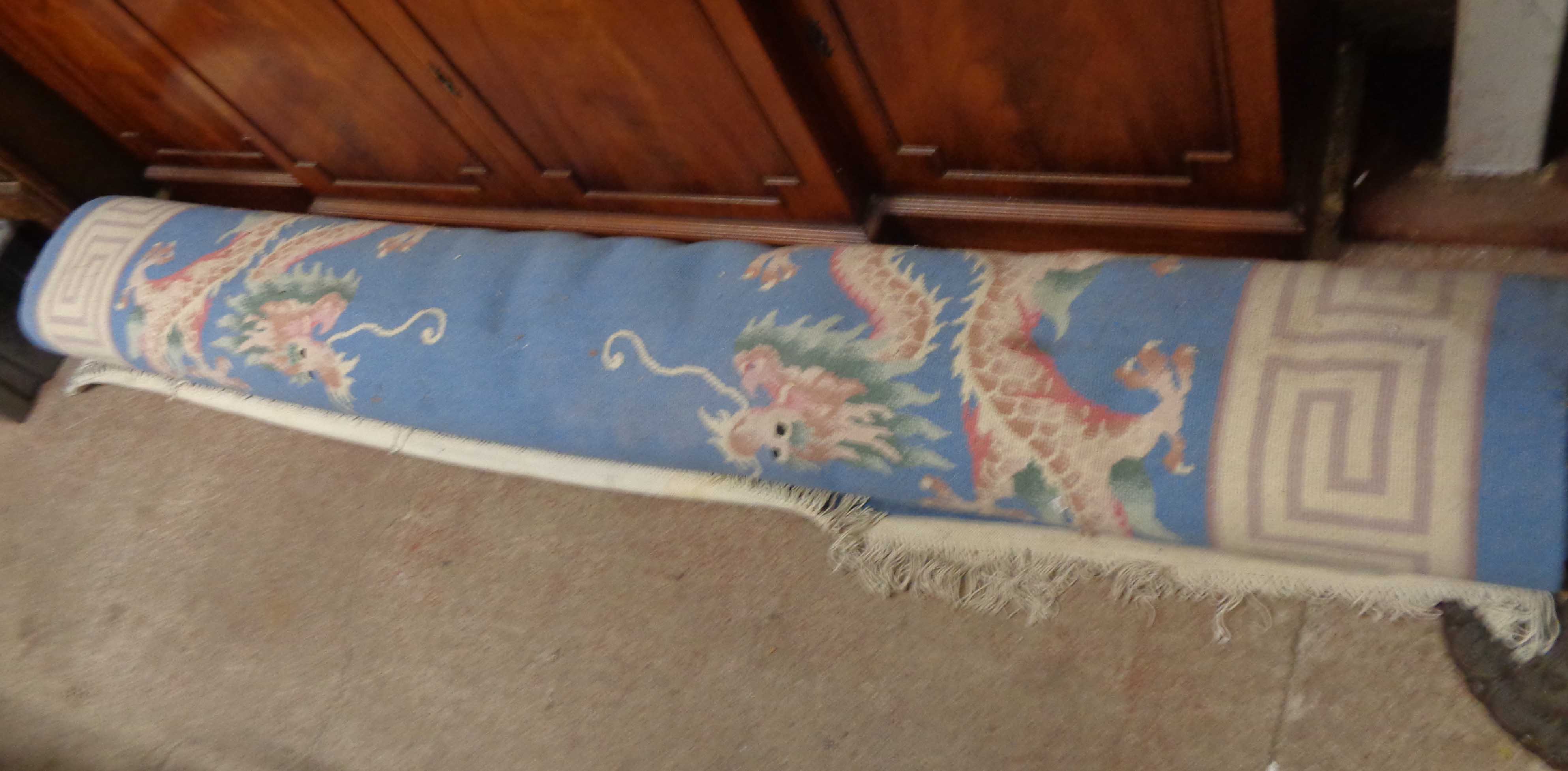 A large modern machine made Chinese washed wool carpet with blue ground