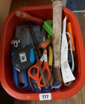 A red crate containing a quantity of tools including tape measure, hammers, etc.