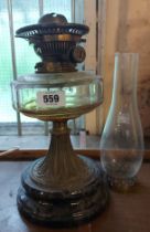 An antique J. Brewford oil lamp with black ceramic base