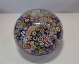 A 19th Century Baccarat silhouette paperweight with carpet ground millefiori and animal silhouette