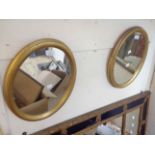 A pair of modern gilt framed oval wall mirrors