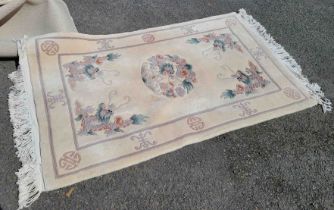 A modern machine made Chinese wash wool rug with dragon decoration on cream ground