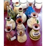 Ten Torquay Pottery scent bottles of various form and maker including one with 'pixie' stopper