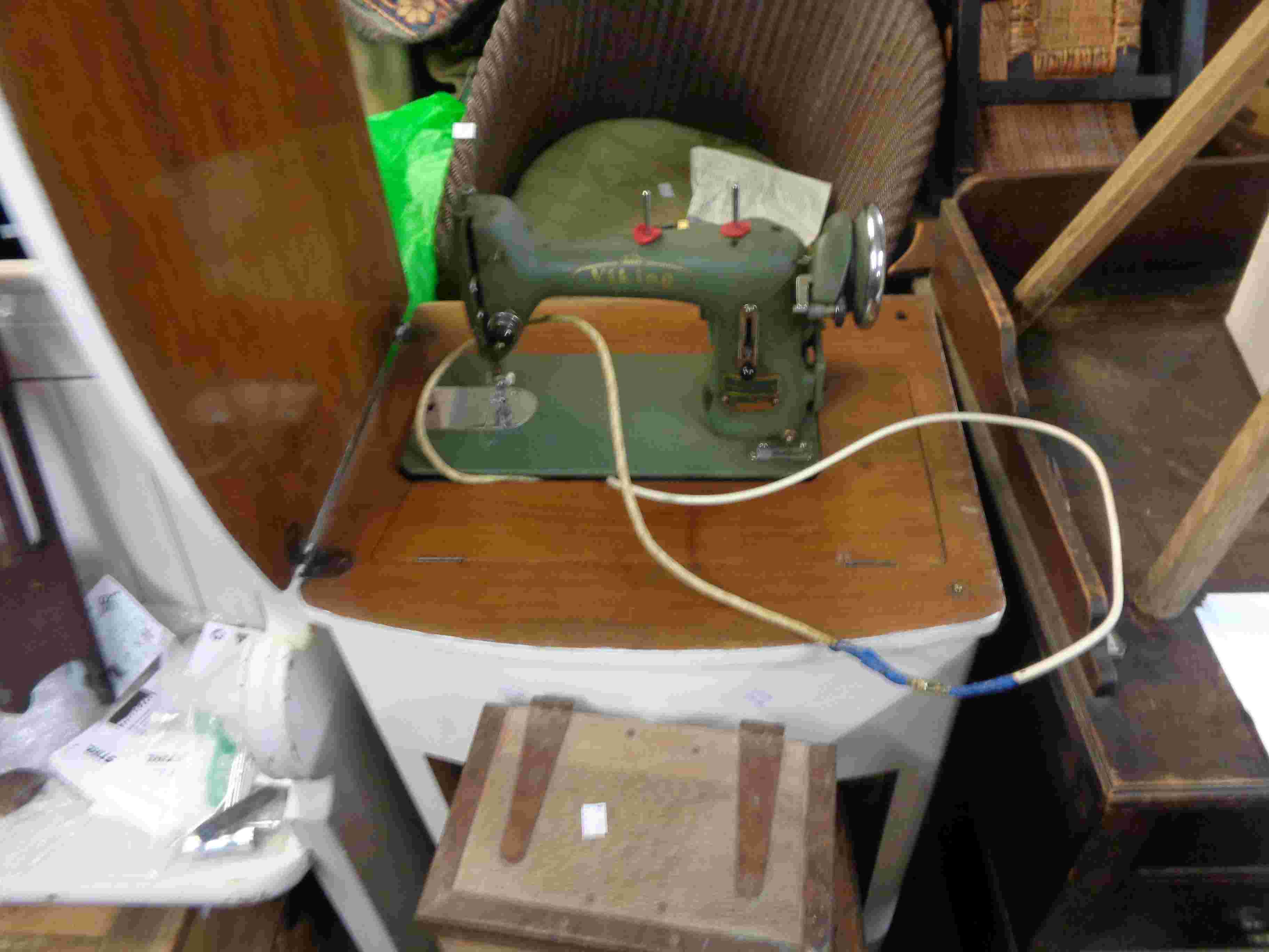 A painted table containing a Viking electric sewing machine - sold as a collectors' item only