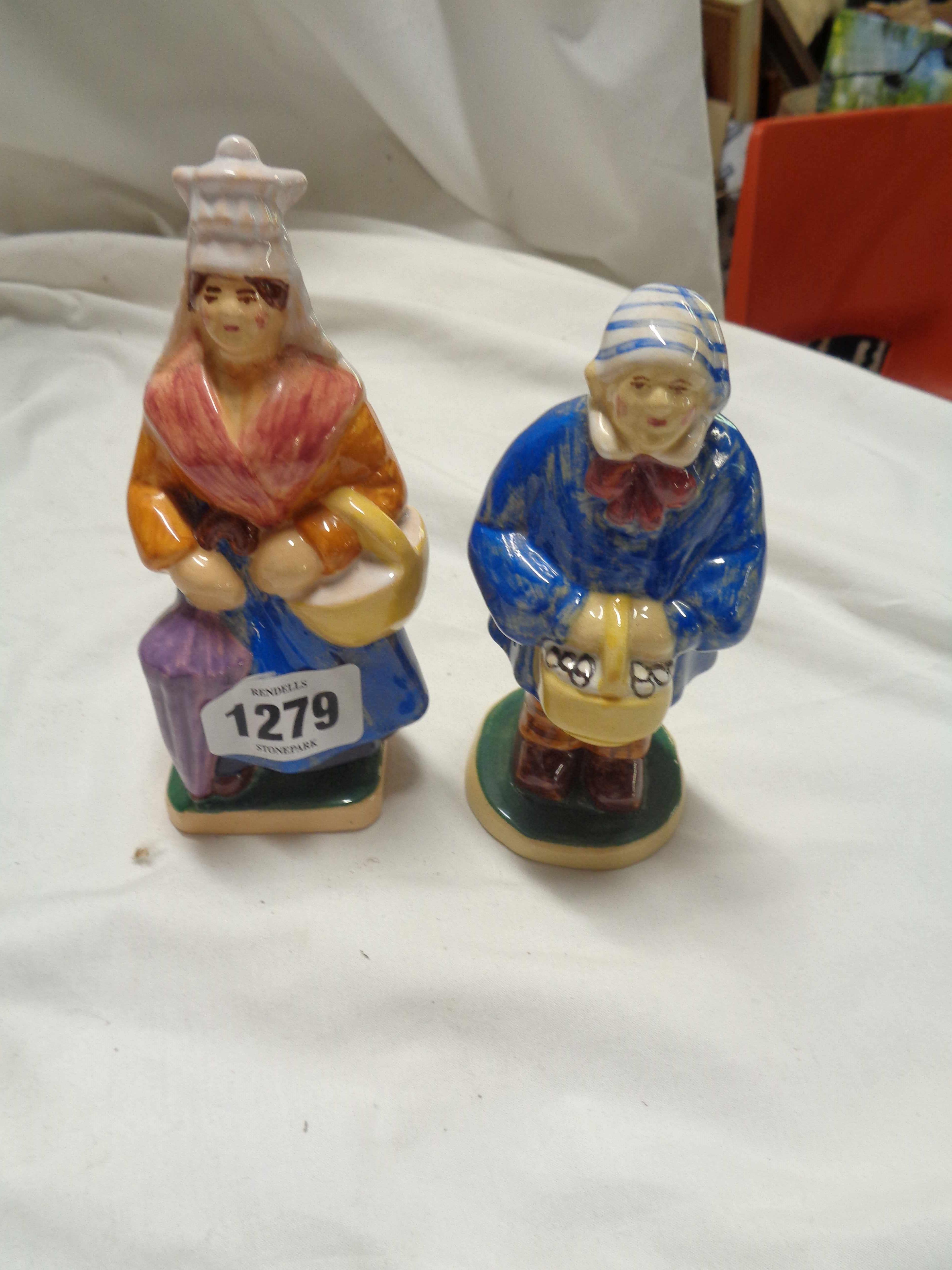 A pair of vintage French Normandie pottery figures, depicting a peasant man and woman off to market